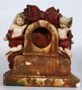 A Victorian plaster / composition pocket watch stand with cherub decoration.