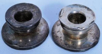 A pair of hallmarked silver candlestick holders.