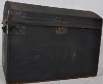 A Victorian black canvas bound dome top portmanteau trunk having hinged lid bearing makers label