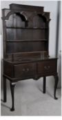 A 1920`s Georgian Jacobean revival solid oak country dresser. The tall cabriole legs with pad feet.