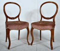 2 Victorian walnut balloon back dining chairs. The decorative cabriole legs with shaped rears.