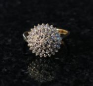A 9ct gold diamond cluster ring. The diamonds approx 20pts mounted to front in cone formation