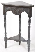 A 19th century Jacobean revival oak corner stand. The turned legs supporting twin tiers. 96cms high