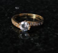 A 9ct gold ladies dress / cocktail cross over ring . The inset diamond being channel set to centre