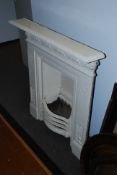 A large 20th century Victorian cast iron painted bedroom fireplace.