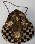 A decorative ladies evening bag with pierced brass top and elaborate hand sewn decoration all over.