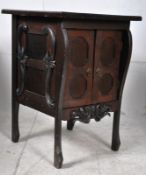 A Victorian oak gothic arts and crafts ecclesiastical side cabinet raised on shaped legs with