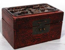 A vintage carved chinese trinket box with brass fittings
