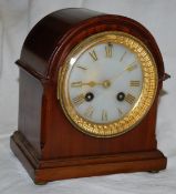 A mahogany arched top mantel clock striking on a gong