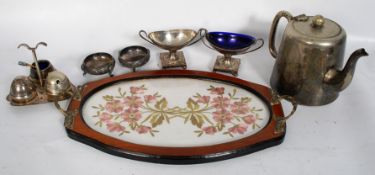 A silk embroidered tray with silver plate cruets, salts etc.