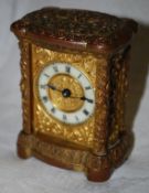 A miniature gilded carriage clock