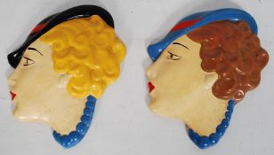 A pair of hand painted Art Deco china wall face masks. 19cm x 15cm.