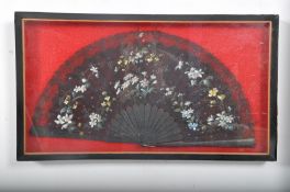 A framed / cased Japanese ladies fan made of intricate lace having foliate decoration. H40cm x