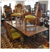 A 1930`s large French solid mahogany refectory draw leaf extending dining table together with 6