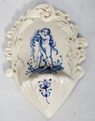 An Italian ceramic holy water wall pocket `Ceramiche D`Art` depicting hand painted child. 20cm