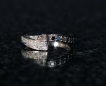 An 18ct gold ladies black and white crossover diamond ring (white gold)