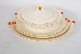 A part Grindley Art Deco service, with platters and tureens in orange deco pattern.