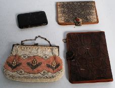 A snake skin purse, a crocodile skin wallet, a tortoise shell cigarette case and bead work purse.