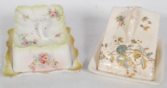 2 cheese dishes, 1 with a rose twist handle, the other of wedge form with foliates.