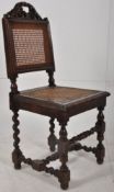 A Victorian carved oak barley twist Jacobean revival hall chair with caned seat and back rest.