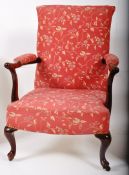 An Edwardian Georgian revivial mahogany button back library / club armchair. The mahogany cabriole