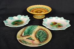 A collection of Victorian majolica to include plates and a tazza