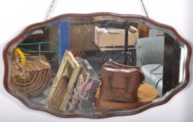 A good Edwardian scallop shaped mahogany wall mirror. The bevelled edge glass set to the mahogany