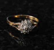 A ladies 9ct gold diamond cluster ring. The diamonds approx 10pts. The centre set diamonds on