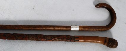 2 antique walking sticks / canes, one with decorative foliate carved shaft and acorn style top, the
