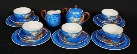 A mid 20th century Japanese transluscent blue tea service embellished with sea dragons. The service