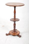 A mid Victorian solid mahogany 3 tier wine table. The turned column to centre supporting 3