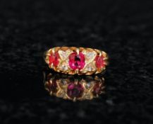 An 18ct gold ladies ruby and diamond ring. The centre set rubys surrounded by diamonds within a