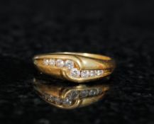 A ladies 18ct gold channel set diamond ring. The diamonds approx 25pts set within a crossover