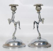 A pair of 1930`s Art Deco chrome plated candlesticks having dancing ladies holding the sconces, sat