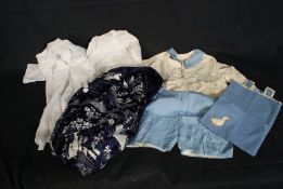 A collection of early 20th century child clothes to include lace garments and A 1950`s Malaysian