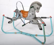 A vintage Triang rocking horse constructed from plastic set onto the original blue painted tubular