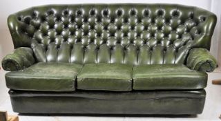 A Green antique style Chesterfield leather sofa settee. The unusual wing backed shaped sofa having