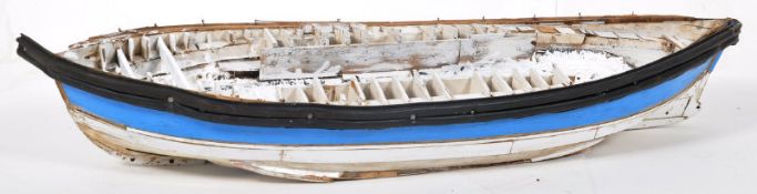 A large  vintage large model boat hull constructed from wood and plastic strips to the exterior