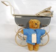 A childs retro 20th enamel painted pram together with a Paddington  bear teddy in blue coat. 69cms