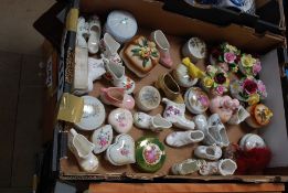 A large selection of novelty china trinket boxes, to include shoes, floral, etc