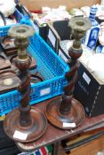 A pair of wooden barley twist and brass candlestick holders.