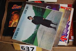 A quantity of LP records in include Status Quo.