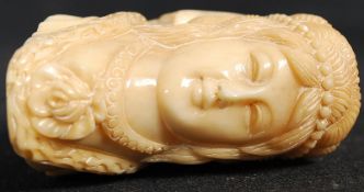 A carved bone pipe in the Art Nouveau style