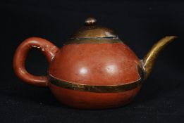 A Chinese yi-xing teapot of stoneware form being brass bound, complete with lid and old repair