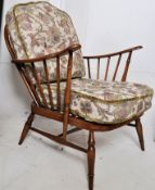 2 1970`s retro Ercol beech and elm armchairs. Raised on turned legs united by stretchers having