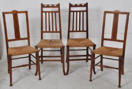 A set of 4 (2 + 2) Victorian arts & crafts oak dining chairs. Rattan weave seats to each with