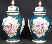 A pair of victoria Austrian green baluster vases with lids being gilt decorated to the leading