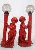 A good pair of red painted 19th century garden cherub lamps / ornaments. Raised on square plinths