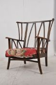 A 1970`s retro Ercol beech and elm armchair. Raised on shaped supports united by stretchers having