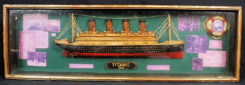 A Titanic hanging wall display comprising of a plaster ship and various reproduction artifacts and